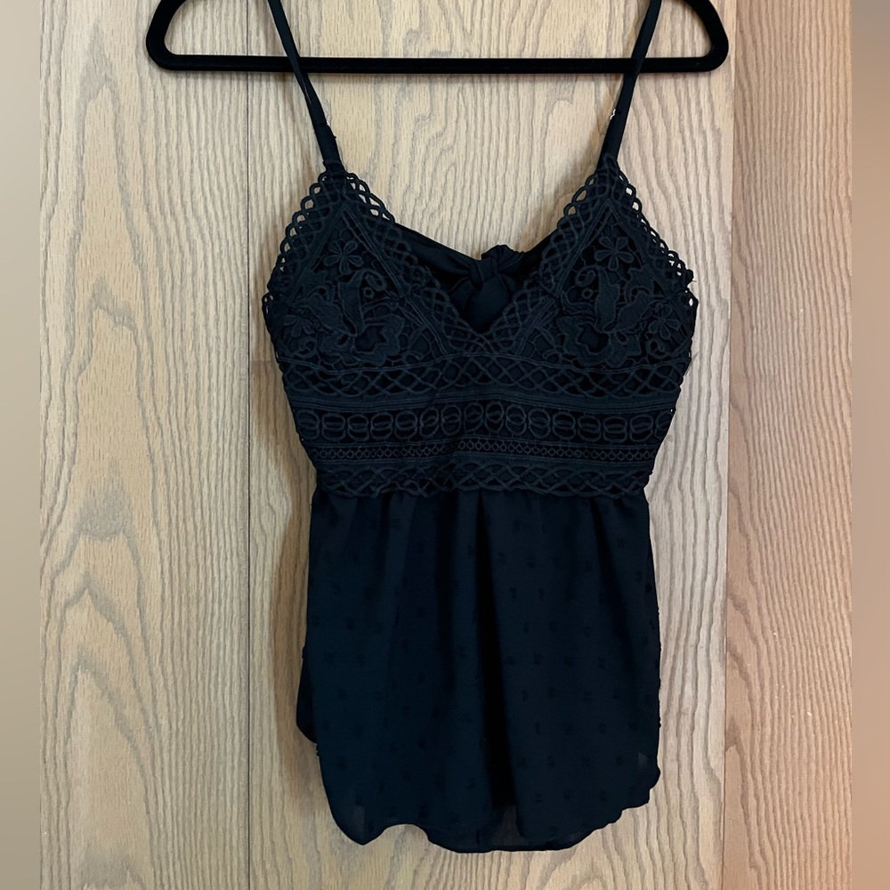 Black tank top with details. Size small. Open back with a bow.